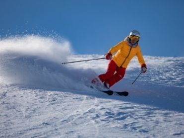 Skier on the slopes yellow jacket