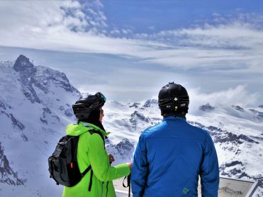Skiers looking over the mountains