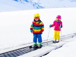 children on magic carpet ski lift